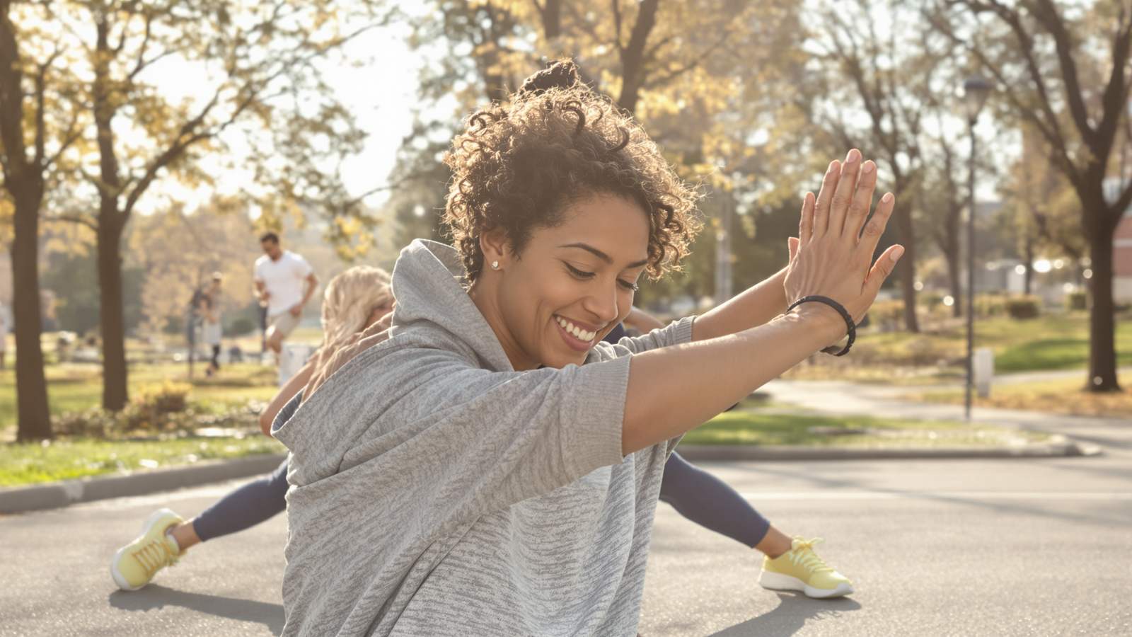 A person stretching energetically outdoors in soft morning light before a run, candid